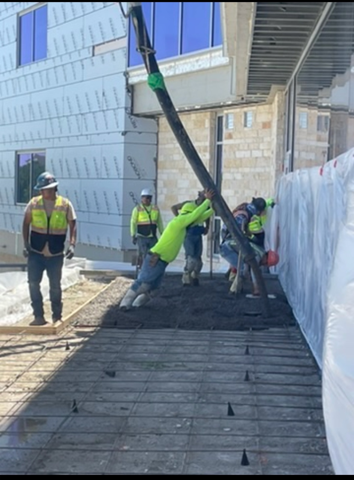 Concrete hose placement on exterior slab pour
